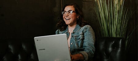 A smiling woman with a laptop